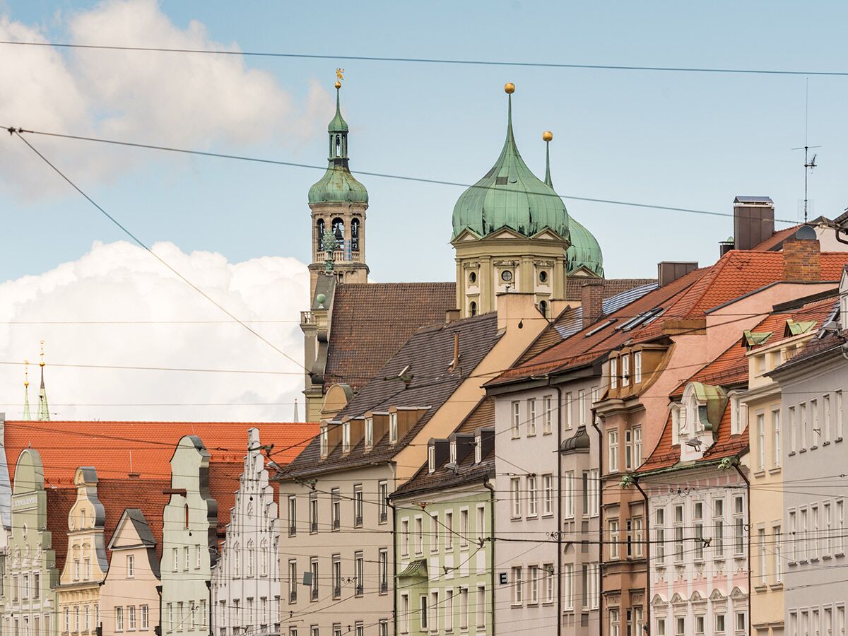 Blick über die historischen Dächer und bunten Fassaden der Augsburger Altstadt mit Perlachturm und Basilika St. Ulrich und Afra.